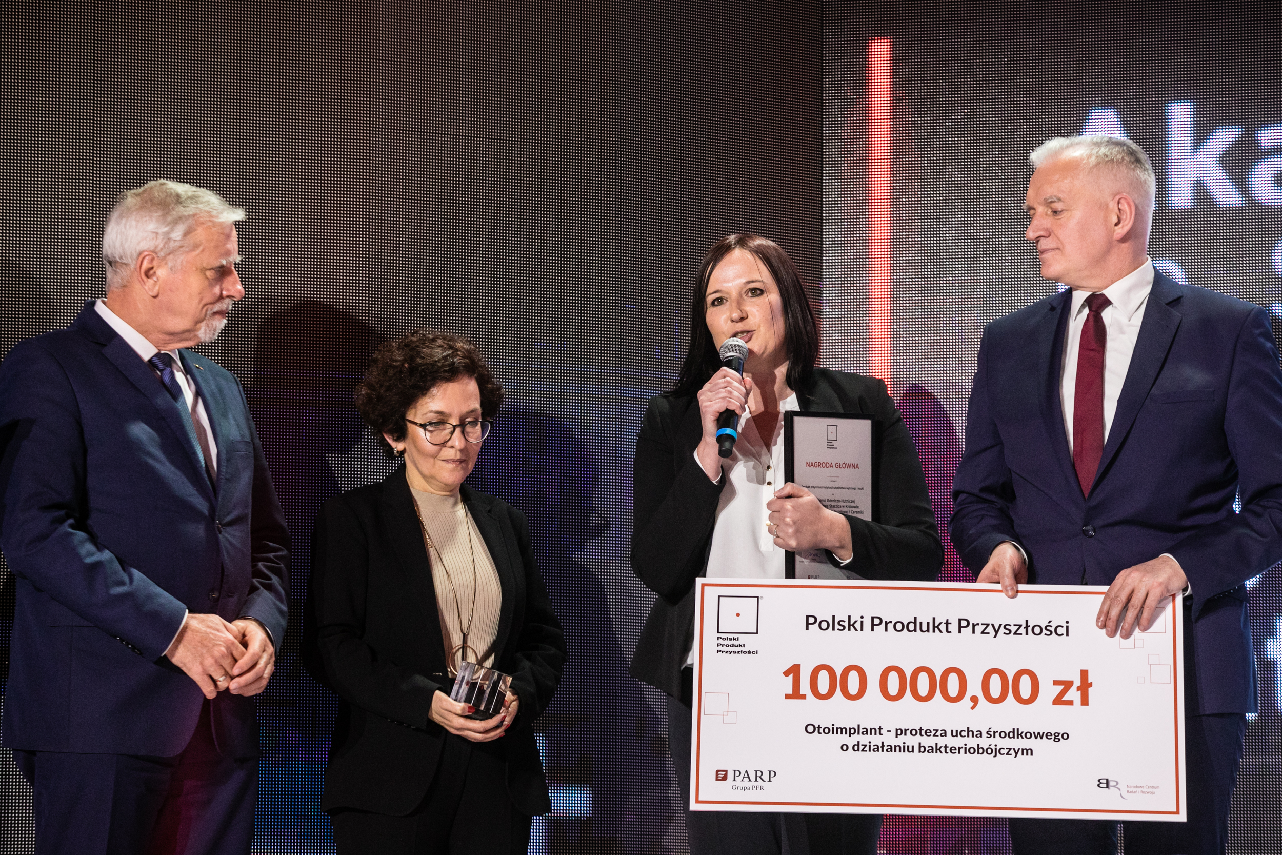 Na zdjęciu Wojciech Kamieniecki i Jarosław Gowin wręczają czek z kwotą 100 000,00 zł dwóm młodym kobietom;